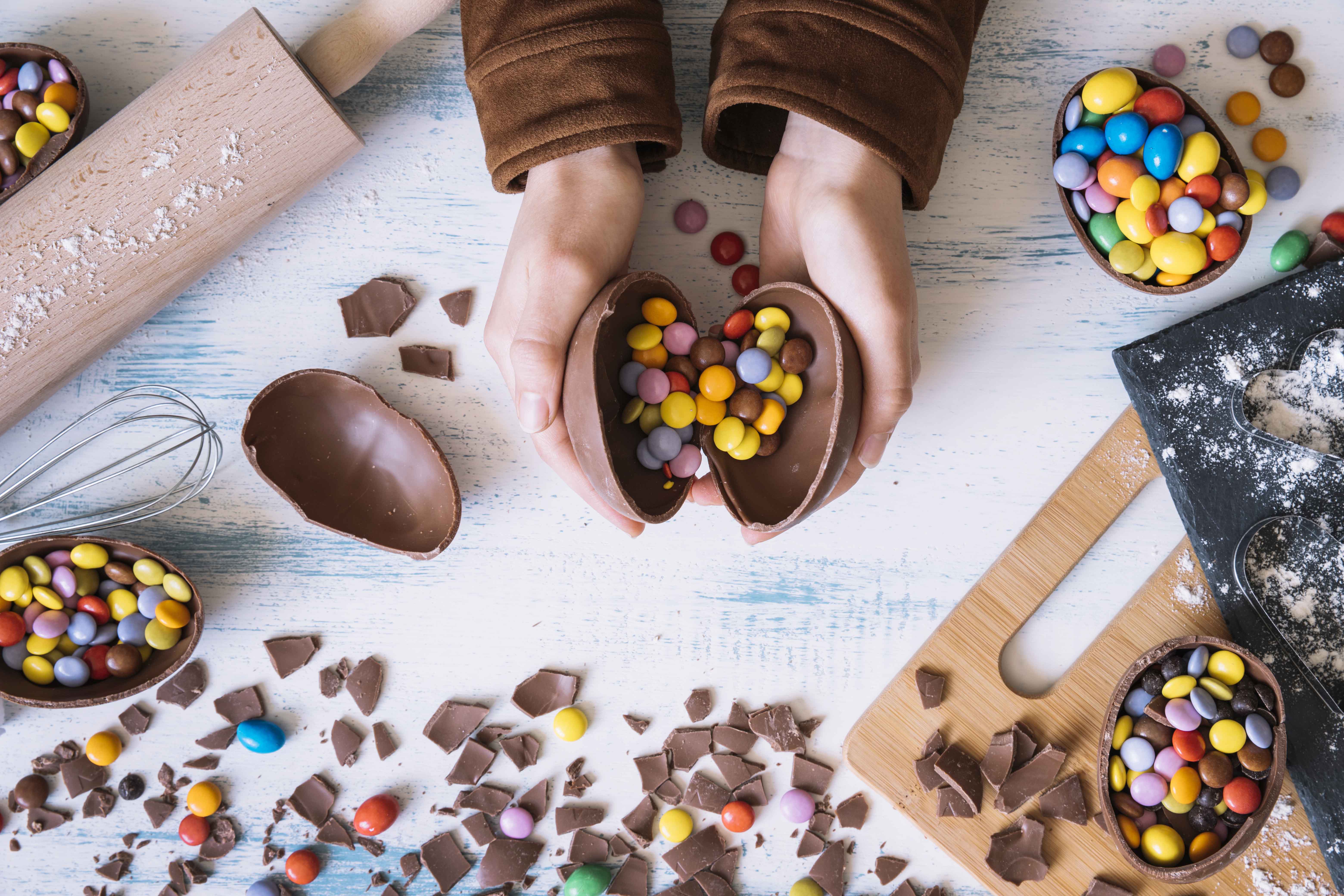 crop hands opening chocolate egg